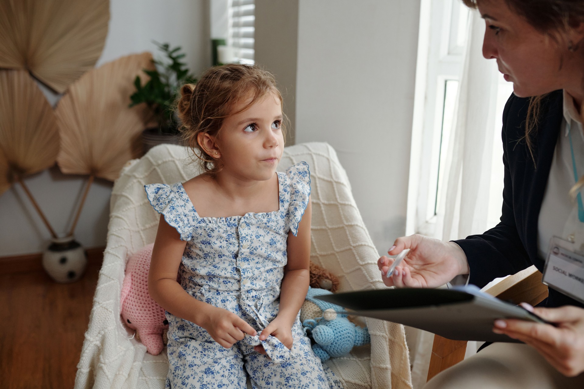 Social Worker Talking To Little Girl
